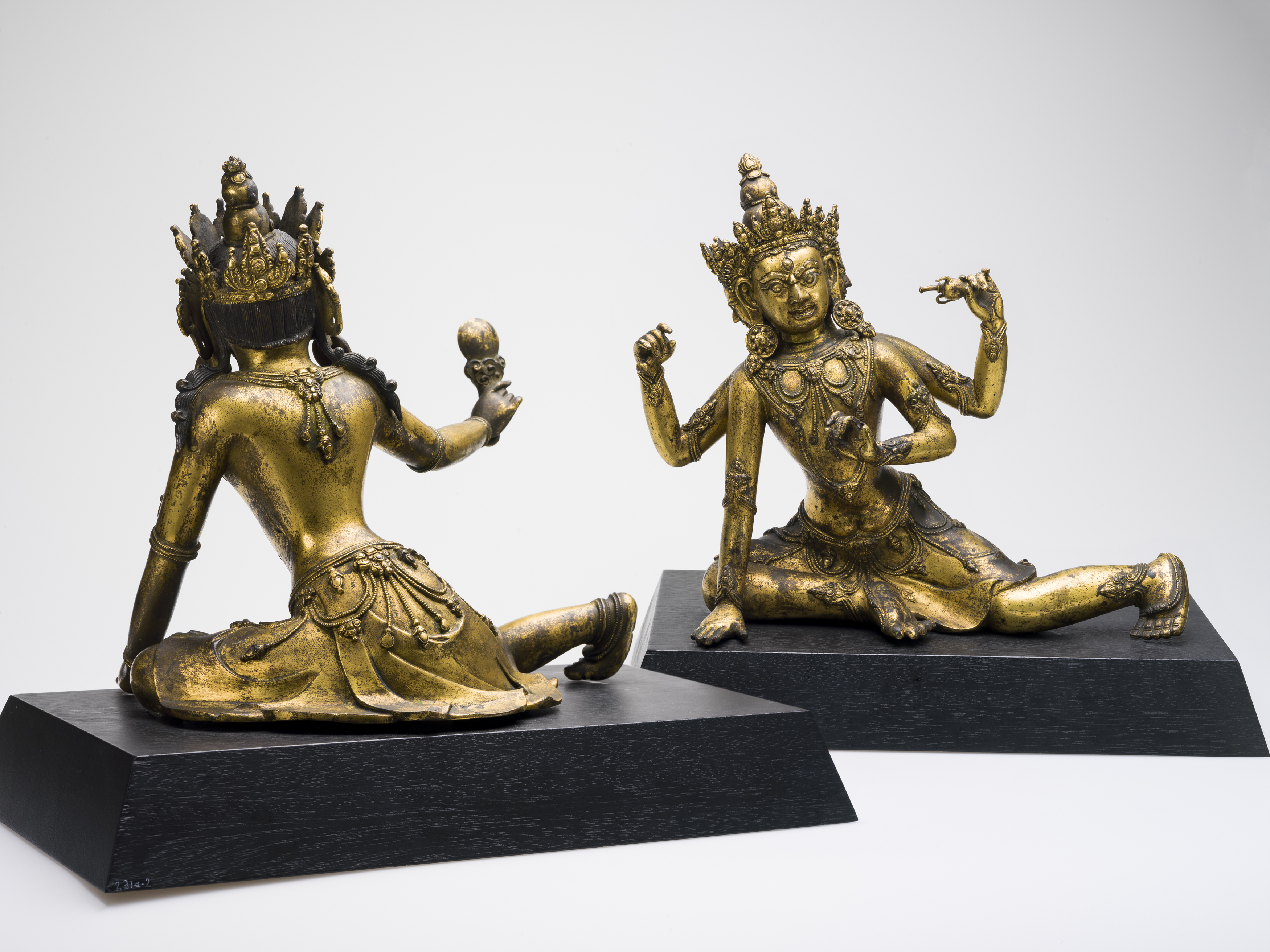 An image of two deity figures looking each other.